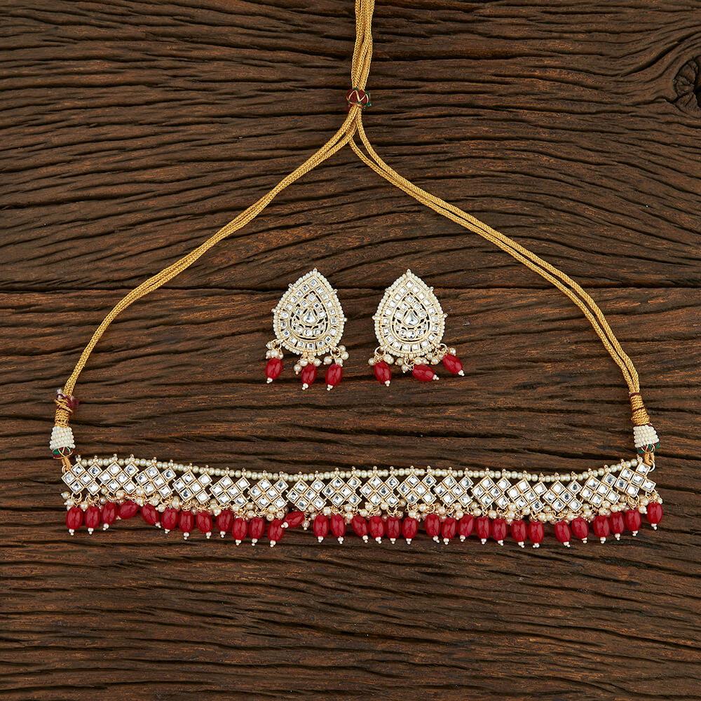 Classic Necklace Set with White Stones, Red Coloured Beads, and Gold-Tone Finish