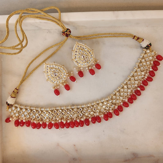 Classic Necklace Set with White Stones, Red Coloured Beads, and Gold-Tone Finish